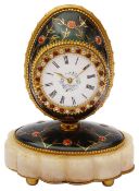 An early 20th c. green enamel gilt metal egg shaped boudoir timepiece