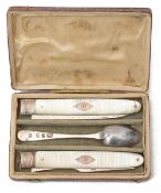 A Georgian silver and mother of pearl folding knife and fork and silver spoon travelling set