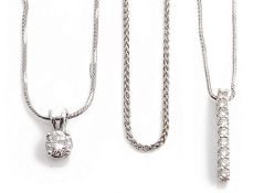A contemporary single stone diamond set pendant