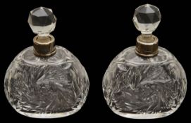 A pair of George V silver mounted cut glass scent bottles,