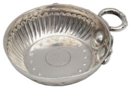A George V silver wine taster set with a George III 1787 silver sixpence,