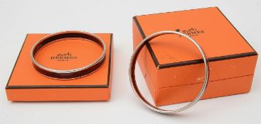 Two Hermes boxed enamel and palladium bangles