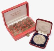 An Austrian cased set of 25 schilling coins and a cased .950 silver prize medal