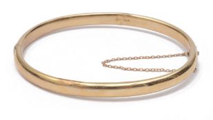 A narrow Continental yellow metal hinged bangle