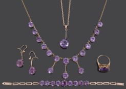 An Edwardian amethyst set drop necklace and a matched suite of similar jewellery