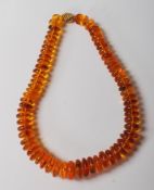 VINTAGE 20TH CENTURY AMBER AND GOLD PEBBLE GRADUATED BEADED NECKLACES