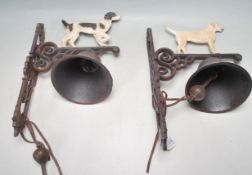TWO VINTAGE STYLE CAST IRON BELLS WITH DOGS IN PROFILE TO THE TOP