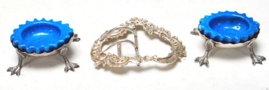 PAIR OF ANTIQUE HALLMARKED STERLING SILVER CRUET DISHES WITH A SILVER BELT BUCKLE.