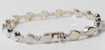 CONTEMPORARY SILVER OPAL AND BLUE STONE TENNIS BRACELET
