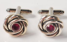 PAIR OF SILVER KNOT DESIGN CUFFLINKS WITH RED STONES