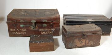 TWO EARLY 20TH CENTURY METAL SHIPPING TRUNKS ALONG WITH TWO SMALL TOOL BOXES WITH VINTAGE TOOLS