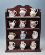 TWELVE ROYAL WORCESTER MINIATURE JUGS / REPLICA JUGS WITH VARIOUS PATTERN