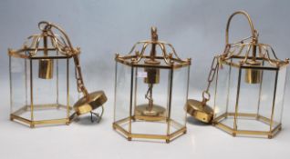 GROUP OF THREE 20TH CENTURY ANTIQUE STYLE BRASS AND GLASS PORCH LANTERNS