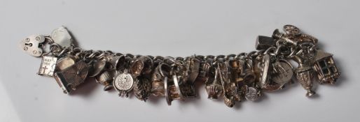 SILVER CHARM BRACELET WITH LARGE AMOUNT OF CHARMS