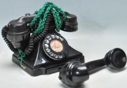 AN EARLY 20TH CENTURY BAKELITE RING DIAL TELEPHONE