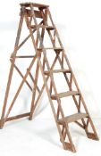 A VINTAGE 20TH CENTURY WOODEN A-FRAME TRESTLE STEP LADDER