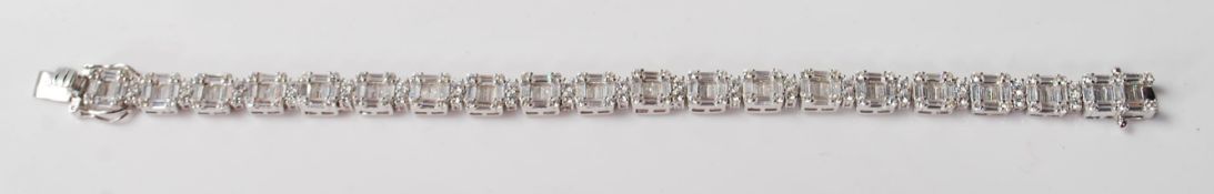 A LADIES SILVER AND CZ TENNIS BRACELET