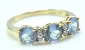 9CT GOLD DRESS RING WITH THREE PALE BLUE STONES SETTING