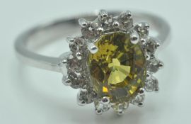 9CT WHITE GOLD RING WITH A PALE GREEN STONE