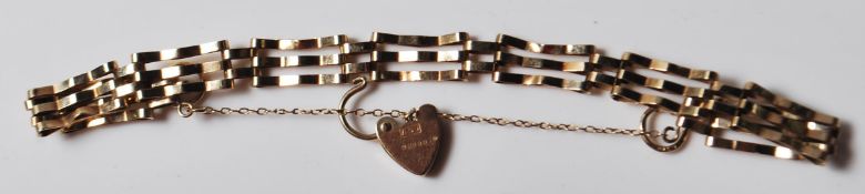 9CT GOLD THREE BAR GATE BRACELET WITH HEART SHAPED PADLOCK.
