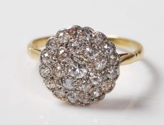 A GOLD AND DIAMOND CLUSTER RING