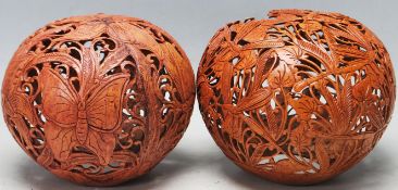 TWO VINTAGE 20TH CENTURY PIERCED AND CARVED EXOTIC NUTS