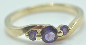 9CT GOLD AND AMETHYST THREE STONE RING
