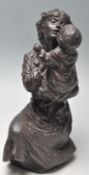 20TH CENTURY ANTIQUE STYLE BRONZED RESIN FIGURE OF A MOTHER AND CHILD.