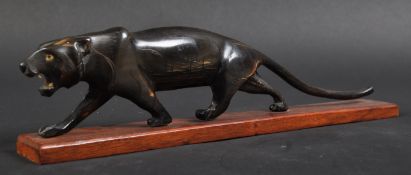 JAGUAR - 20TH CENTURY CARVED HORN PROWLING JAGUAR STATUE