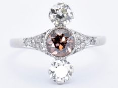 PLATINUM AND DIAMOND THREE STONE CHAMPAGNE RING