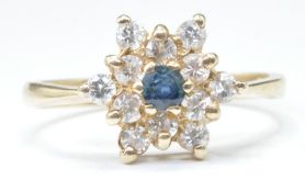 9CT GOLD BLUE AND WHITE STONE FLOWER HEAD RING