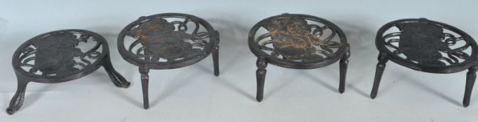 FOUR ANTIQUE STYLE CAST IRON TRIVETS