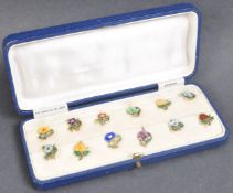 CASED SET OF 1920S STERLING SILVER & ENAMEL CUP TOKENS