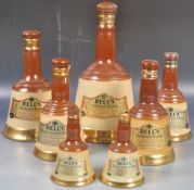 COLLECTION OF BELLS CERAMIC WHISKY DECANTERS