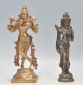 TWO BRASS DEITY FIGURINES DEPICTING KRISHNA AND DEWI SRI.