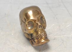 BRASS VESTA CASE IN THE FORM OF A SKULL.