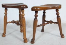 PAIR OF 20TH CENTURY OAK SADDLE STOOLS