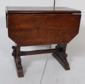 1930’S OAK DROP LEAF COFFEE TABLE WITH METAMORPHIC TABLETOP