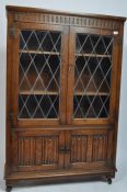 JACOBEAN REVIVAL OAK AND LEADED GLASS DISPLAY CABINET
