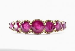 9CT GOLD AND RUBY SEVEN STONE RING