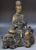 20TH CENTURY BRONZE FIGURE OF GUANYIN ON FOO DOG