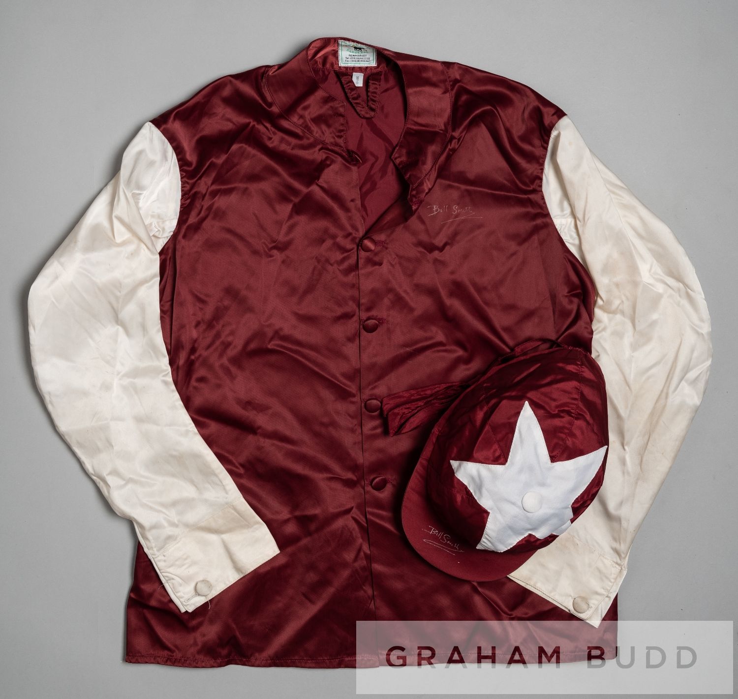 Racing colours of Sheikh Mohammed 1990s, maroon with white sleeves and star on cap, signed by the