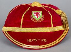 Red Wales International cap awarded in 1975-76, the red velvet with gilt tassel and braiding,