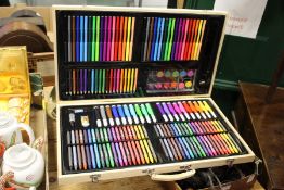 A fitted box containing numerous felt tip pens, crayons, pencils etc.