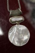 A decorative pendant and chain.
