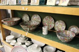 A collection of Canton porcelain to include three large bowls, five plates and a similar brush