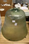 A green glass bell shaped cloche (lacking handle).
