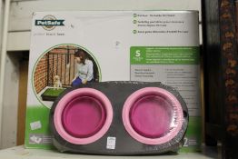 A pet loo, boxed and unused, together with a pet bowl.