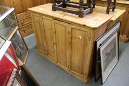 A pine cupboard with bi-fold doors.