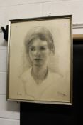 A portrait bust of a young girl, charcoal, signed.